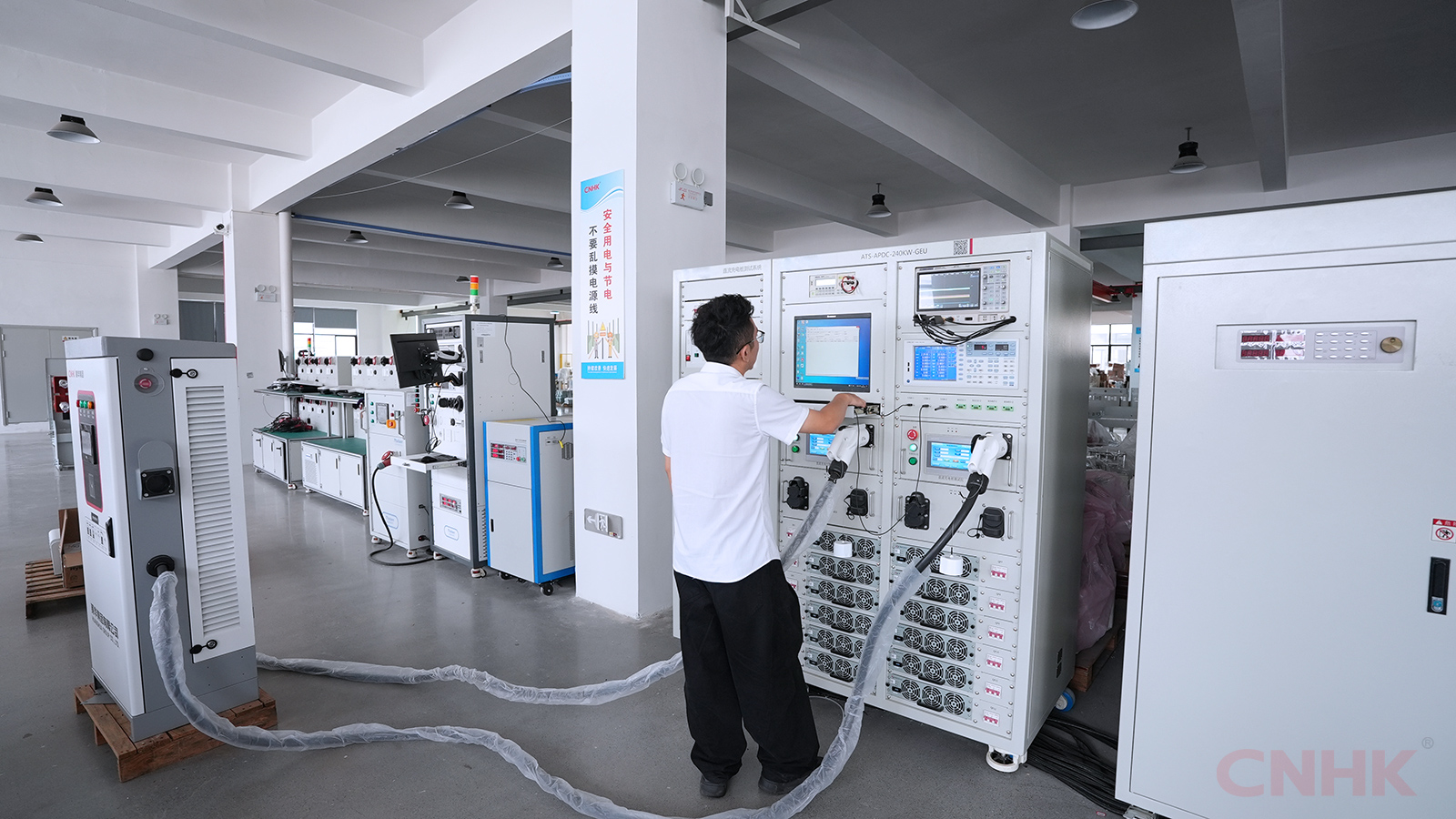 Technician testing an EV charger on the workshop test bench