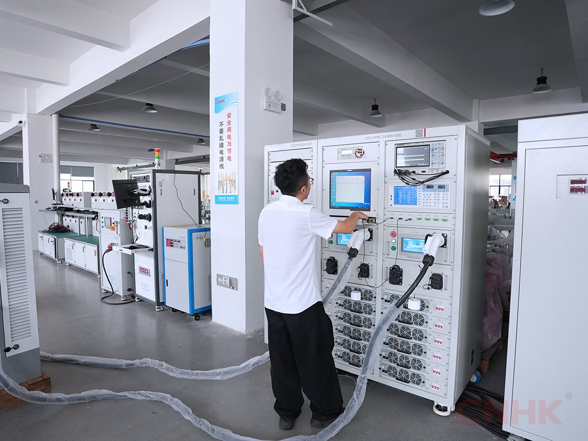Technician testing an EV charger on the workshop test bench