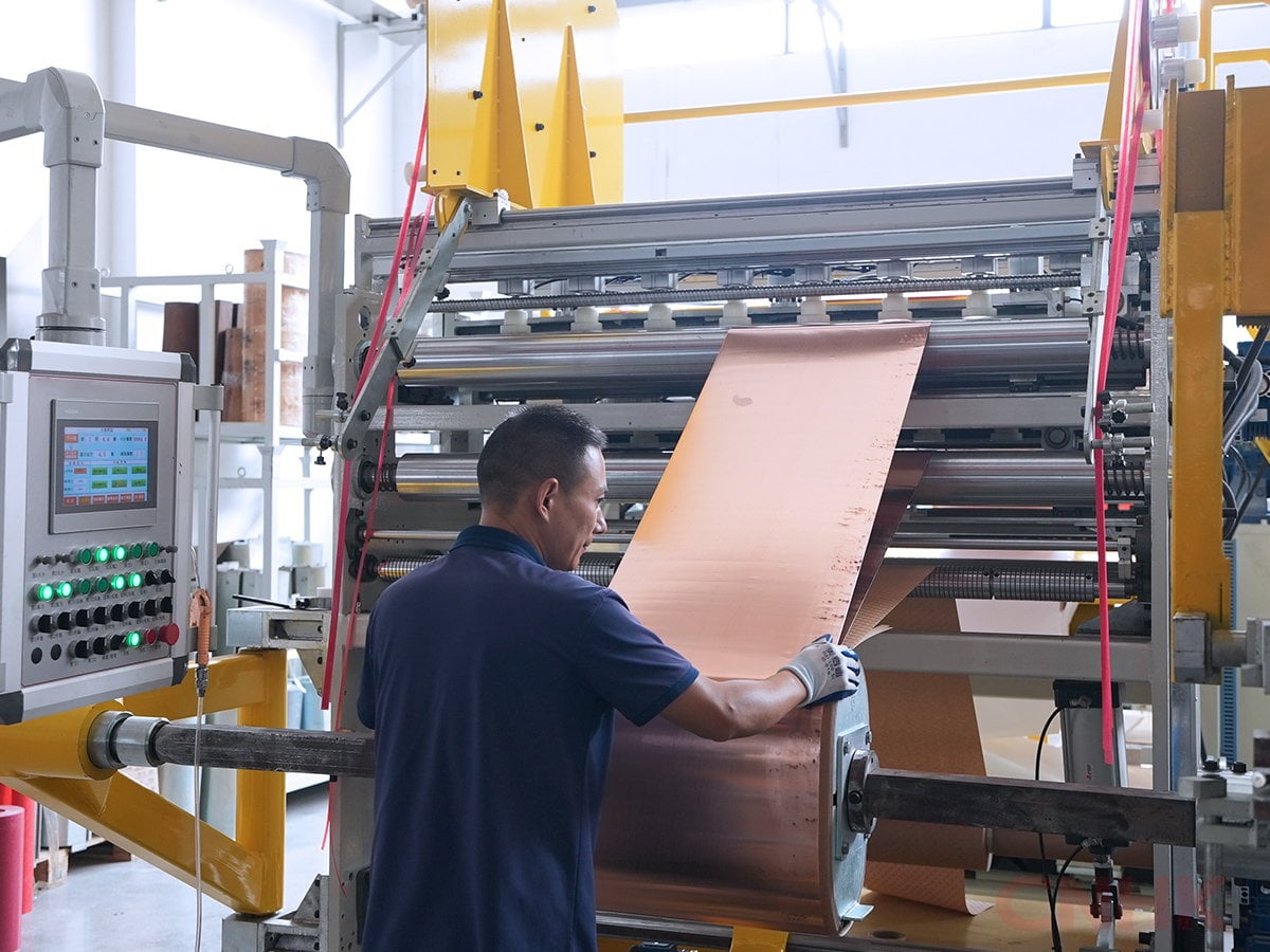 Operator feeding copper strip on the processing line
